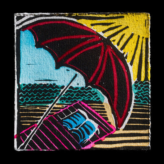 This linocut print, titled "Sunny sunshine - a day at the beach" by Tommy, features a serene beach scene with vibrant colors. The artwork showcases a parasol in red and black hues against a bright yellow sun and blue sky, set amidst wavy turquoise lines representing water and a striped pink and black towel on the ground.