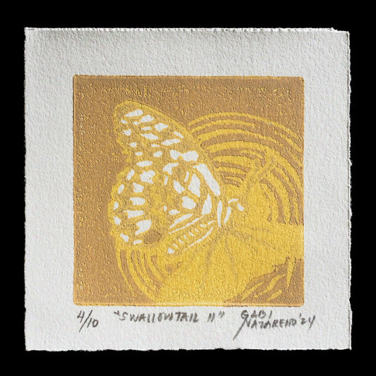 This linocut print, titled "Swallowtail II" by Gabi Nazareno, showcases a swallowtail butterfly in white against a warm golden-yellow background. The intricate design is set against a textured off-white paper border, adding depth to the overall composition.