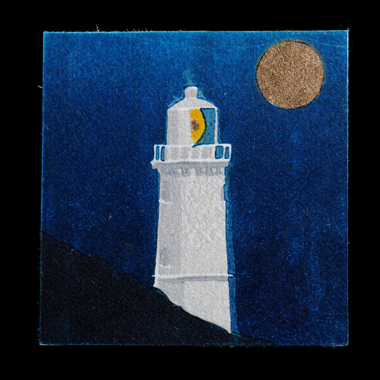 This linocut print, titled 'Guiding Lights', features a serene nighttime scene with a lighthouse standing tall against a dark blue sky. The artist's use of bold lines and vibrant blues creates a striking visual effect, while the lighthouse itself appears to be casting its beam out into the darkness.