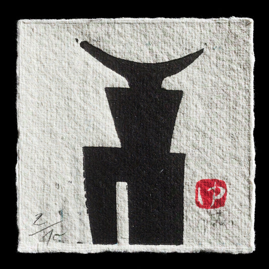 This print, titled "Minotaur I" by Juliane Petri, showcases a striking black woodcut image of a Minotaur's head against a white background. The bold design is complemented by a red square with an illegible white symbol in the bottom-right corner and a signature in the lower left corner, adding subtle yet distinctive details to the overall composition.