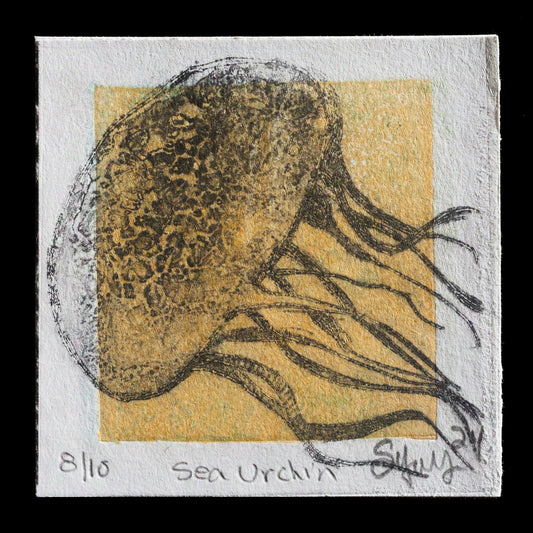 This monoprint titled 'Sea Urchin' by Scott D.S. Young showcases a stunning depiction of an oceanic creature. Created using drypoint techniques, the print features a predominantly tan color scheme with darker brown shading on top, set against a pale yellow rectangle background. The sea urchin is intricately detailed, its spines and texture skillfully rendered in varying shades of brown.