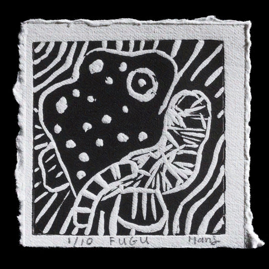 This linocut print, titled "FUGU" by Hans Chew, presents a striking black-and-white composition featuring a large mushroom with spots against a solid background. The intricate details and textures in the lino block are skillfully rendered in white ink, creating a visually appealing contrast with the black background.