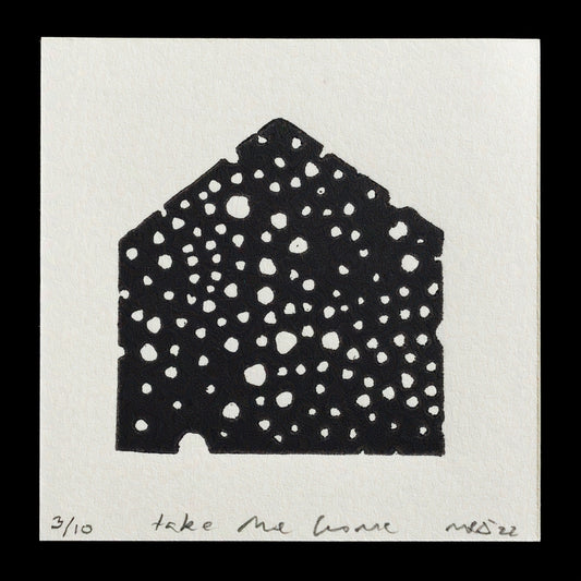This print, titled "Take Me Home" by Kareen Adam, features a striking black house shape with numerous white holes in various sizes against a light grey background. The artwork showcases the artist's unique linocut technique, creating intricate details and textures that add depth to the composition.