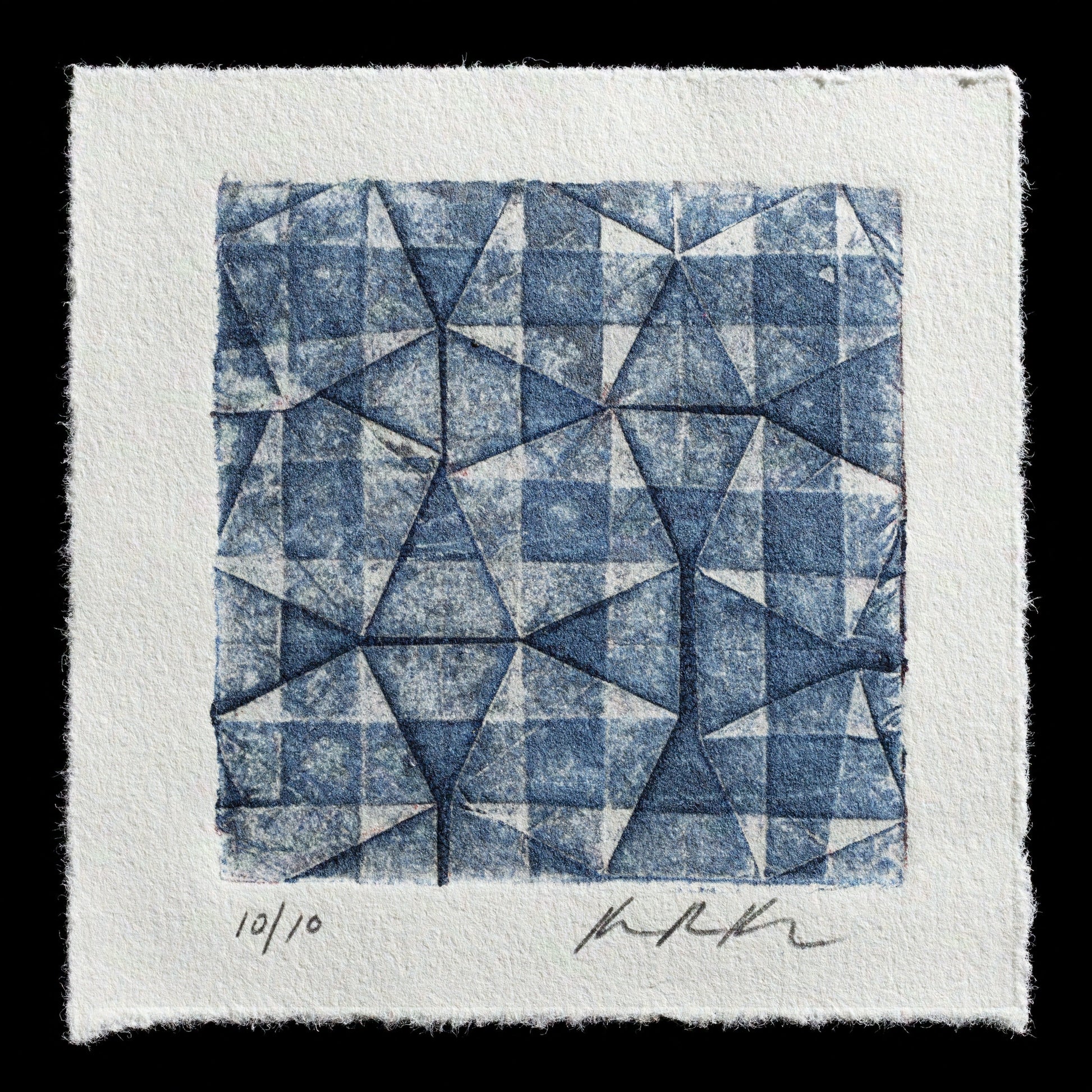 This print, 'Tumbling' by Karen Ruth Karlsson, showcases a dynamic arrangement of triangles in blue ink on white paper, evoking movement through its overlapping forms. Created using collagraph techniques, the artwork presents a captivating visual display.