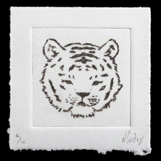 This etching print features a tiger's head in black ink on white paper, showcasing Natasha Gardos' skillful use of drypoint technique. The artwork presents a detailed and expressive depiction of the animal's face against a clean white background.