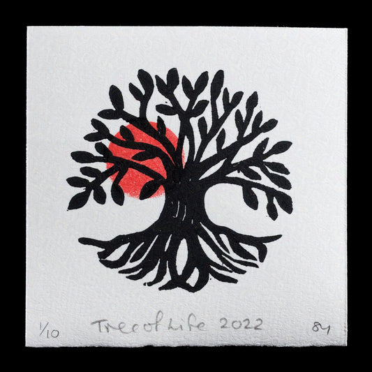 The "Tree of Life" print, created by Susan Yeates through linocut technique, features a stylized tree with abstracted leaves and roots, set against a white background with red accents.