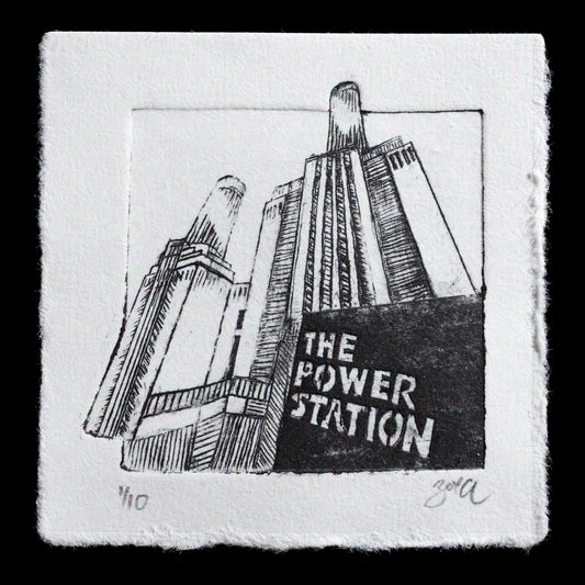 This print, "Mini Battersea" by Zoe Cloke, showcases a miniature, monochromatic depiction of the iconic Battersea Power Station in London. Created using TetraPak techniques, the black-and-white artwork features delicate lines and precise details that capture the essence of this renowned landmark. The artist's skillful rendering brings the power station to life on paper, inviting viewers to appreciate its intricate architecture.