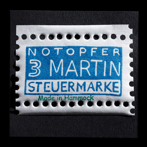 This artwork, NOTOPFER 3 MARTIN, is a linocut creation by Andreas Vietz. The image features a blue stamp-like design with white text, showcasing the artist's unique style and technique.