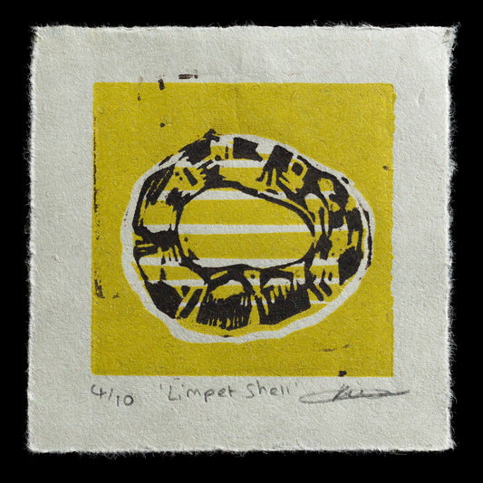 The 'Limpet Shell' linocut print by Kath Bell features a yellow square with an oval-shaped limpet shell in black, printed on light grey paper. The title is handwritten at the bottom of the print. This piece showcases intricate details and textures characteristic of linocut printing techniques.