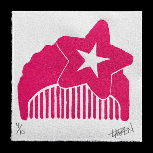 This print, titled "Pink Comb Study" by Lauren Medford, showcases a vibrant pink linocut design featuring a stylized comb with four teeth and a star in the center. The artist's use of bold color and simple yet effective composition creates a visually striking piece that invites contemplation on the subject matter.