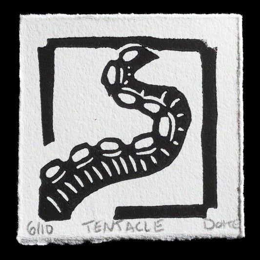 This linocut print by Ashley Doke features a striking black-and-white design. At its center is an abstract tentacle, rendered in bold black lines with white highlights, set against a square frame with thick black borders. The artist's signature and the title 'Tentacle' are discreetly printed at the bottom of the artwork.