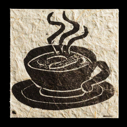 This print, 'Morning Coffee,' features a stylized coffee cup with steam rising from it, crafted using linocut techniques and printed on handmade paper. The dark brown ink provides a rich contrast to the natural texture of the paper.