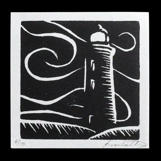This linocut print, titled 'To the Lighthouse' by Isabella J. von Lichtan, features a striking black-and-white depiction of a lighthouse standing tall against a dark sky, evoking a sense of serenity and isolation in the face of nature's vastness.