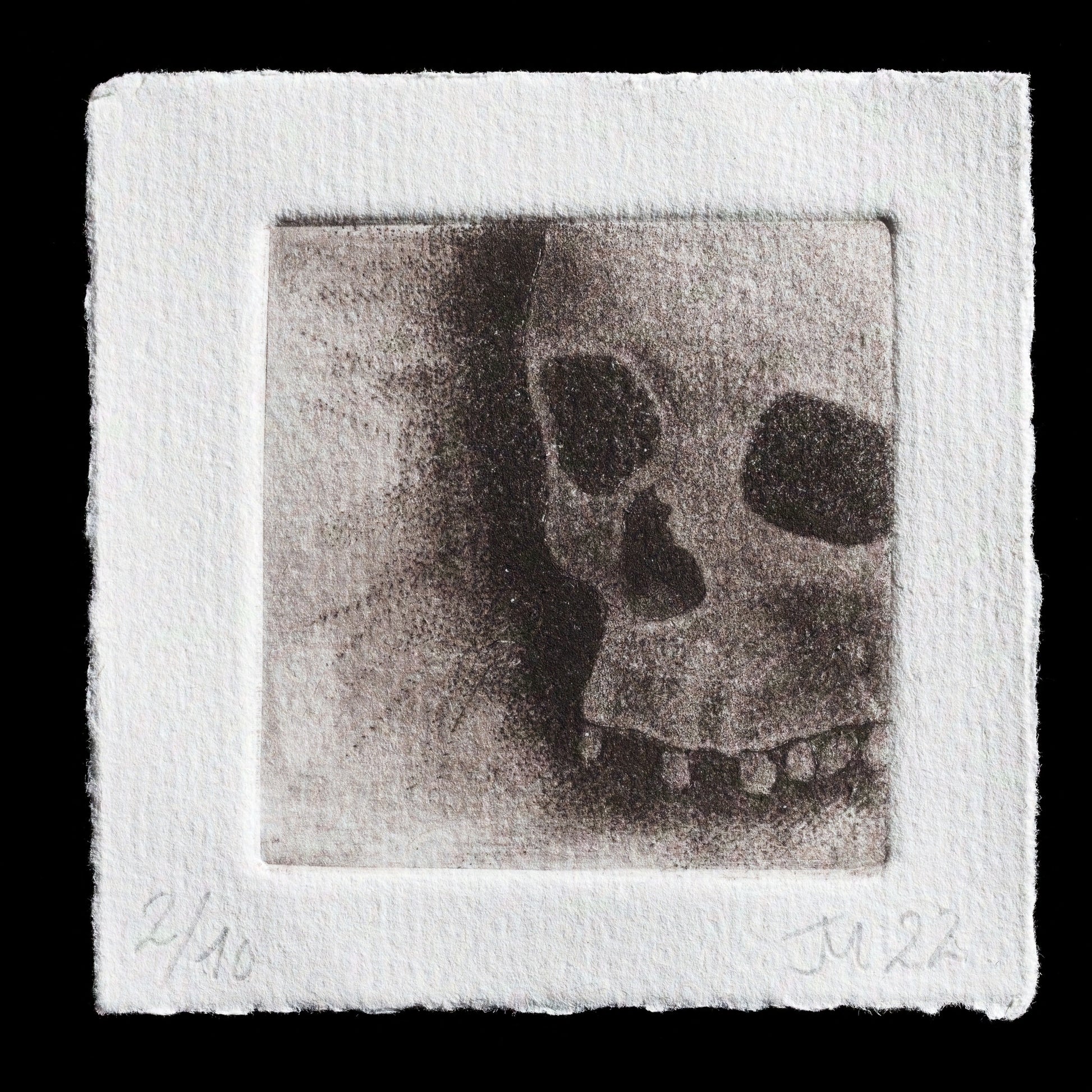 This monochromatic etching, titled "Skull" by Jess Milhausen, showcases a detailed skull rendered in black ink on textured white paper. The drypoint technique creates subtle texture, while mezzotint adds depth and dimension to the image. The artist's use of black ink against a stark white background draws attention to the intricate details of the skull's features.