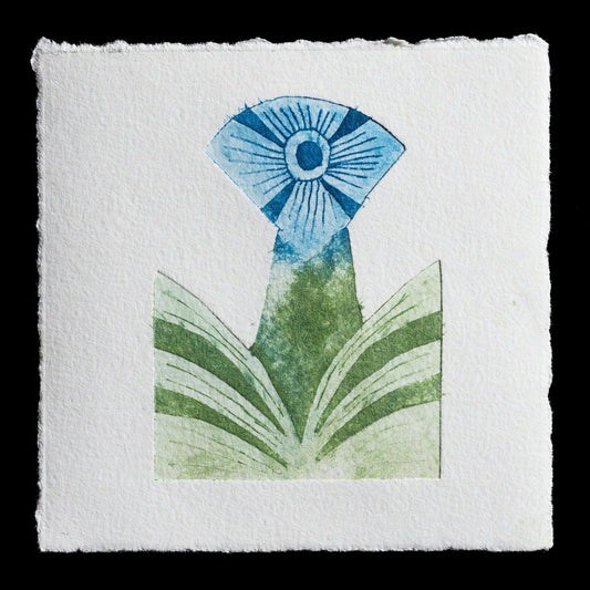 This etching titled "sproing" by Cyndy Patrick presents a striking composition characterized by a vibrant blue flower with white lines radiating from its center, set against a backdrop of green foliage. The artist's use of contrasting elements creates a visually appealing contrast that draws the viewer's attention to the intricate details of the print.