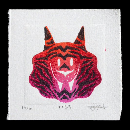 This linocut monoprint by Em Jackson (Lanabagu) features a stylized tiger's head in vibrant reds and oranges. The bold design showcases the artist's skillful use of color and texture, with intricate details that bring the subject to life.