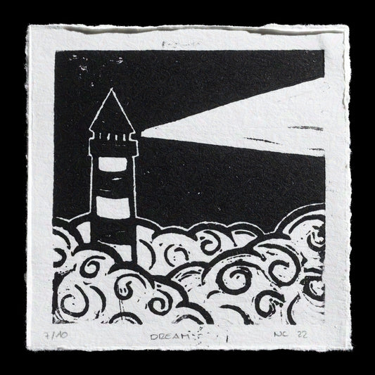 The artwork 'Dream' by Nina Chabek showcases a serene scene featuring a lighthouse set against a night sky, accompanied by stylized waves in the foreground. The print was created using linocut techniques on paper, with a color palette that includes shades of black and white.