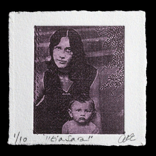 This captivating monochromatic photopolymer print is titled 'TIA SARA' by artist ANA RAQUEL ESKREIS. The artwork features a woman holding a young child, with a subtle and intricate design that showcases the artist's skillful use of photopolymer techniques. The dominant color scheme is a range of greys, adding to the print's timeless and elegant aesthetic.
