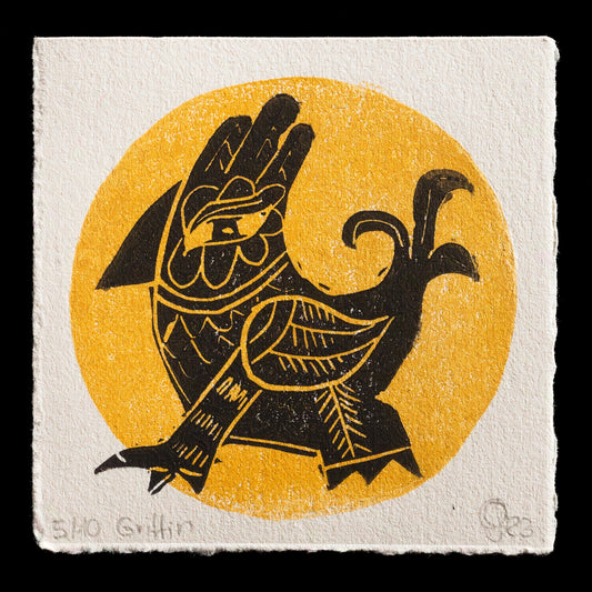 This linocut print, "Griffin" by Britta Lange, features a striking black griffin silhouette set against a vibrant yellow circle background. The circular shape is reminiscent of the sun or moon, while the griffin's design evokes ancient mythology and symbolism. The contrast between the dark, bold lines and bright, sunny colors creates a visually captivating piece that showcases Lange's skillful use of linocut techniques.