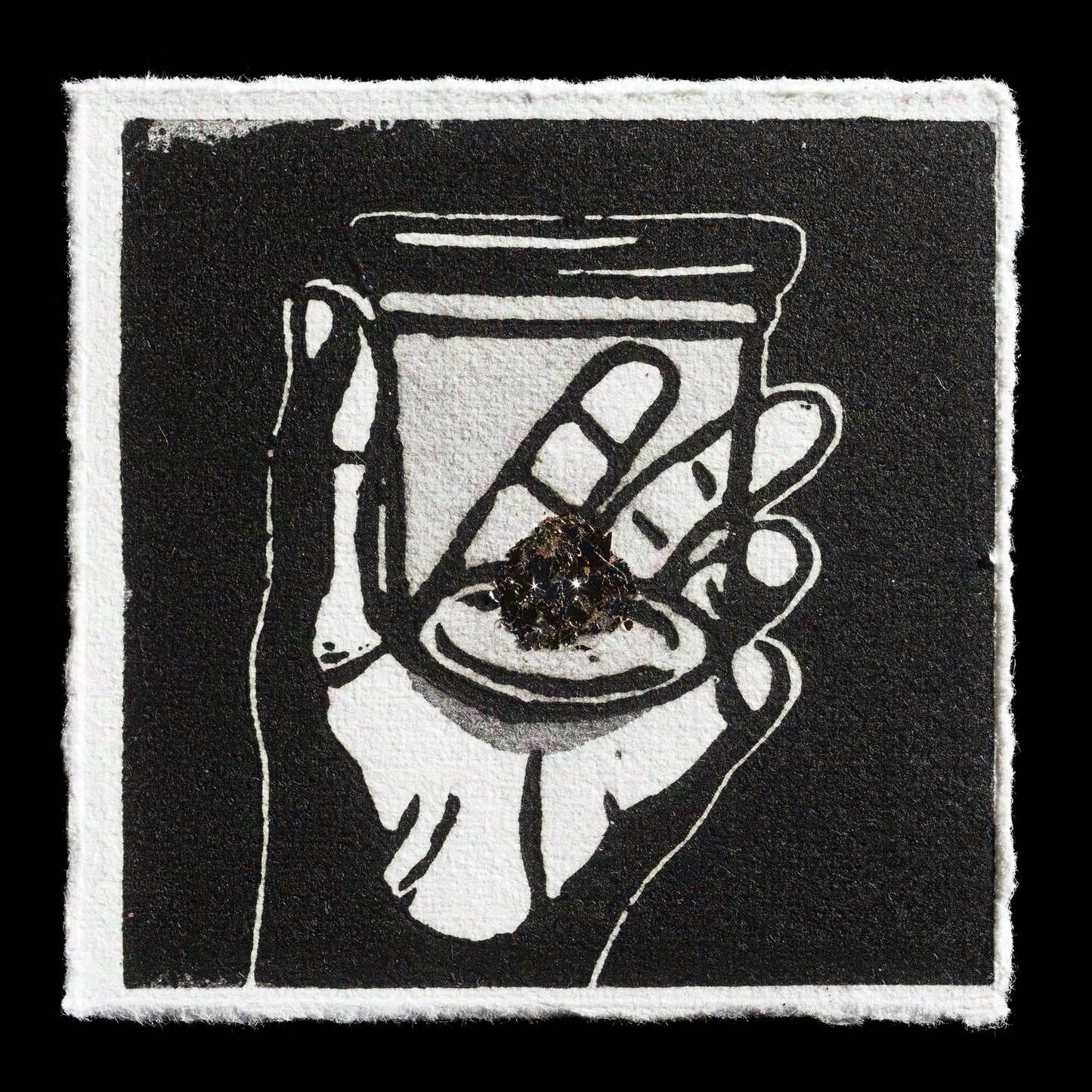 The print "Memory" by Antje Zacharias showcases a hand holding a jar with an eye inside, rendered in black and white on textured paper with rough edges. The artwork combines linocut and mixed media techniques, presenting a thought-provoking visual narrative.