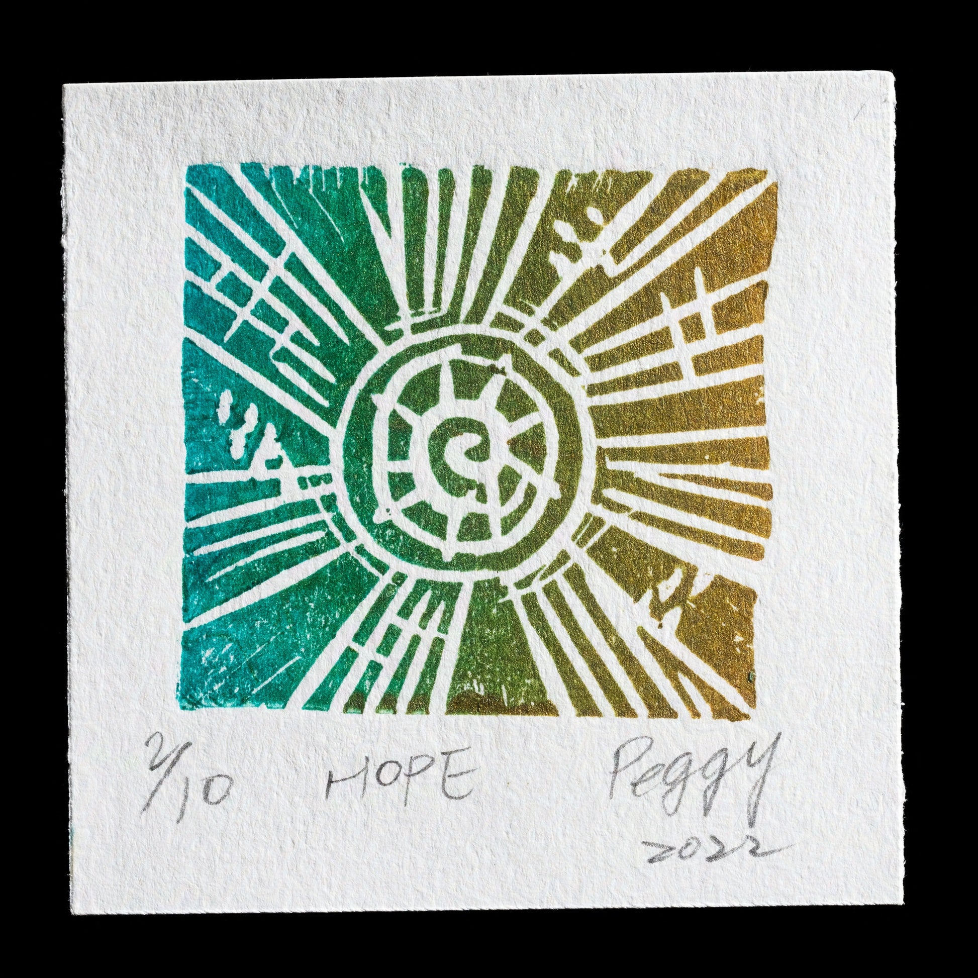 This artwork, titled 'HOPE' by Peggy Lee, showcases a vibrant square design featuring a stylized sunburst motif in shades of green and gold. The intricate details within the sunburst pattern are created using a combination of intaglio, relief print, engraving, and monoprint techniques, resulting in a visually striking piece that exudes hope and positivity.