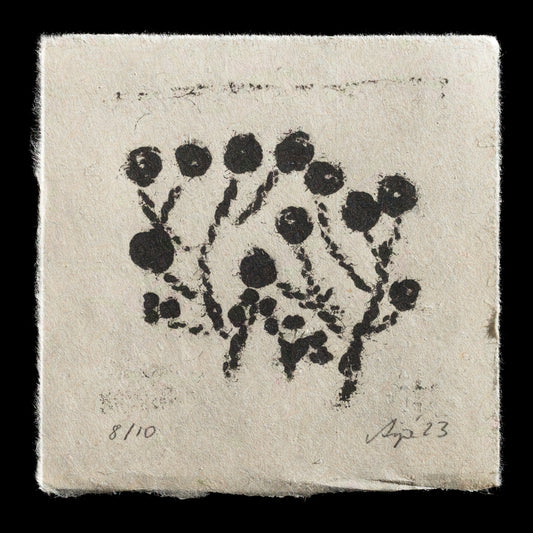 This print, titled "Embroidered Garden" by Anja R. Lampert, showcases a unique blend of techniques: relief print and collagraph. The black ink relief print features circular motifs that resemble embroidered flowers on light tan paper, creating a harmonious contrast between the vibrant and muted tones.