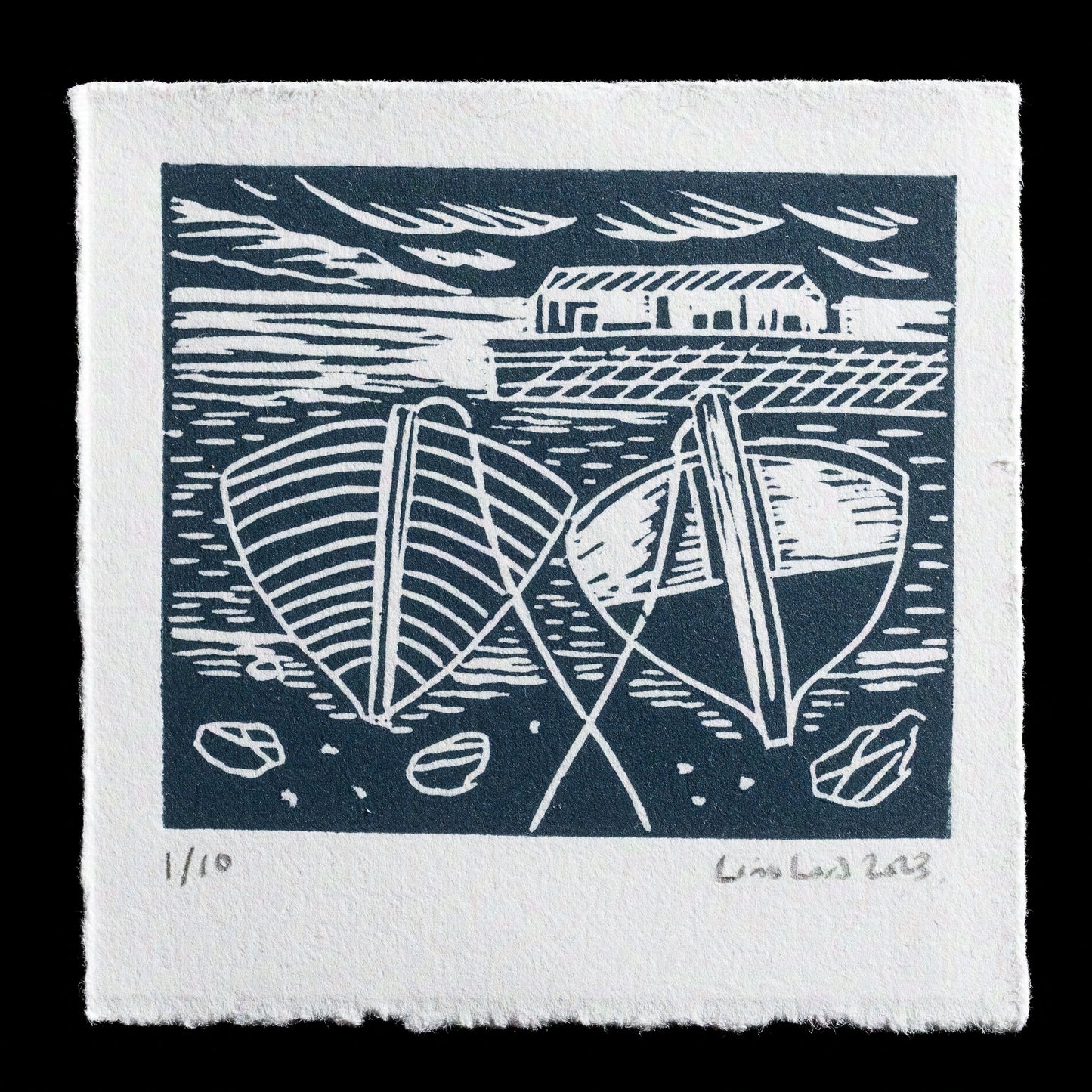 This linocut print, "Quiet day in the harbour" by Lino Lord, features two boats moored at a dock with their sails furled, set against a serene backdrop of calm water reflecting the sky above. The artist's use of blue and white hues creates a peaceful atmosphere. The print is signed and numbered 1/10, suggesting it may be part of a limited edition series.