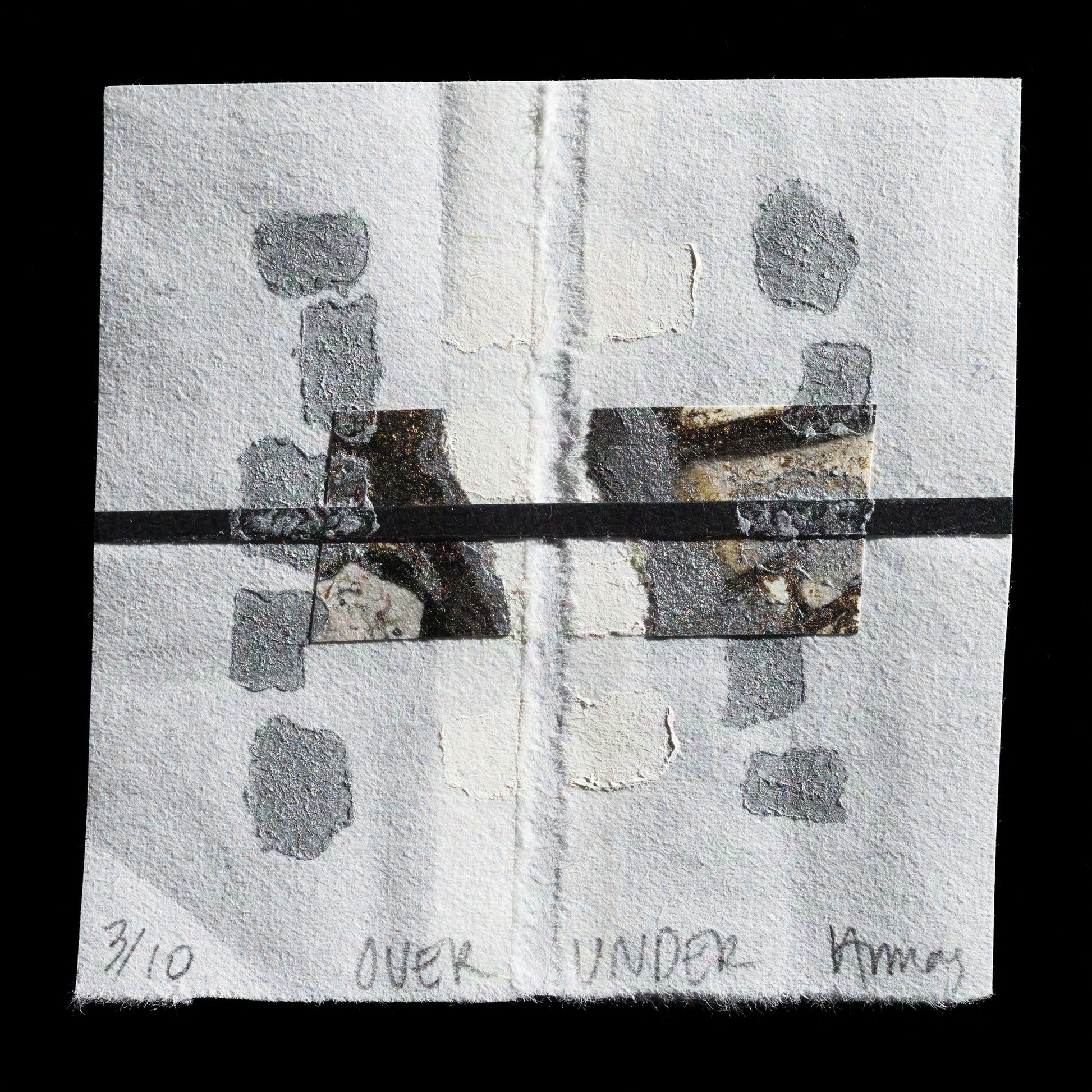 This abstract print, titled 'Over Under', is a collagraph artwork by Victoria Ballas Armas. It features a predominantly white composition with subtle grey and black accents. The arrangement showcases rectangular shapes in varying sizes, while smaller irregular forms are scattered throughout the background. A central horizontal line separates the composition into two distinct sections.