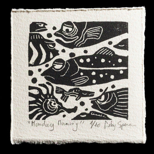 This print features a striking black-and-white image of fish swimming in water, crafted using the linocut technique by artist Gaby Spencer. The composition showcases a serene underwater scene, with fish swimming amidst bubbles and ripples on the surface. The bold black lines contrasted against the white background create a visually appealing effect.