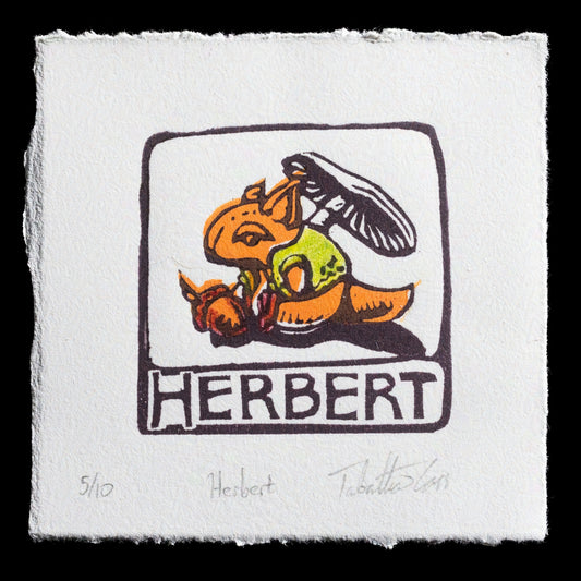 This linocut print titled "Herbert" by Tabatha Cass showcases a whimsical illustration featuring a cartoon character with an orange body and green shirt, accompanied by a black hat. The title is prominently displayed in bold letters at the bottom of the image, while the artist's signature is discreetly placed in the lower right corner.