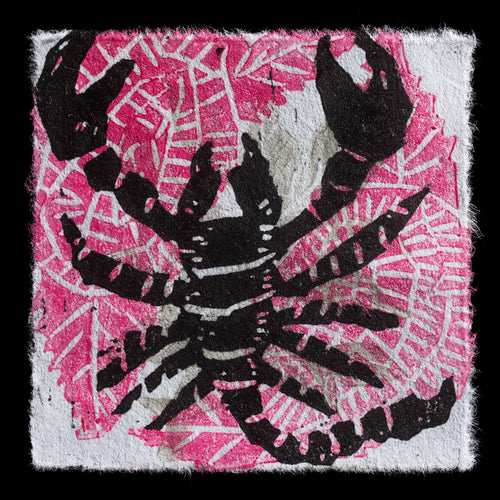 The image depicts a linocut artwork titled '�For Eugene�' by Cecelia Tio. It features a black crab with pink and white accents against a black background. The crab's body is divided into two halves, showcasing its underside on the left side of the print and its backside on the right. The contrasting colors create a visually striking effect, emphasizing the crab's unique characteristics.