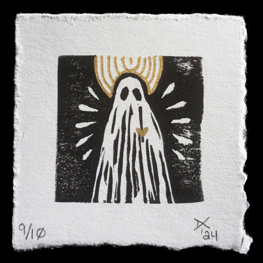 This print is a captivating linocut piece titled 'Still, Love Persists' by artist Dana Campbell. Created in 2024, it showcases a striking black background with a white ghostly figure adorned with gold accents, including a golden crown and heart on its chest. The artwork features bold lines and a mix of mediums, exuding a sense of mystique and emotional depth.
