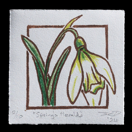 This print, "Springs Heralds" by J. Claire Dean, features a stylized floral motif in muted green tones against a white background. Created through a combination of woodcut and mixed media techniques, it showcases the artist's unique approach to design.