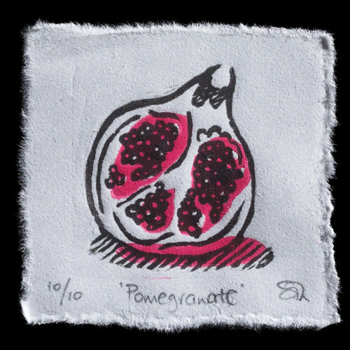 This print, titled 'Pomegranate', is a linocut artwork by Sam Thomas. It features a stylized pomegranate with seeds in pink and black, showcasing Thomas' unique artistic style.