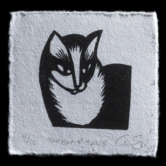 This captivating woodcut print from "Top Hat & Tails" by Aren Straiger showcases a stylized black badger head set against a light blue-gray background. The bold lines and geometric shapes employed in this piece create an intricate yet harmonious composition, inviting the viewer to appreciate its unique design.