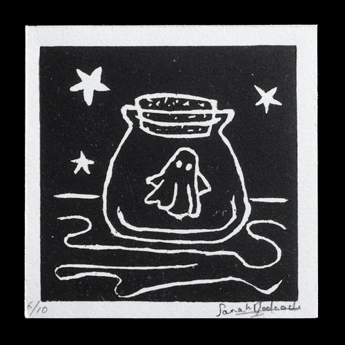 This linocut print, titled 'Ghost in a Jar' by Sarah L. Badcock, showcases a ghostly figure enclosed within a jar. The black background features white lines that outline the jar, with a wavy line at its base and three stars above it. A small ghost is visible inside the jar, surrounded by white dots. This print is part of a limited edition run, with only 10 copies available.