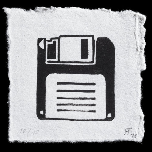 This print, titled 'Floppy,' is a linocut artwork by Ramona Fontaine. The monochromatic piece features a stylized depiction of a floppy disk in black ink on white paper. The artist's use of bold lines and geometric shapes creates a striking visual representation of the iconic computer accessory.